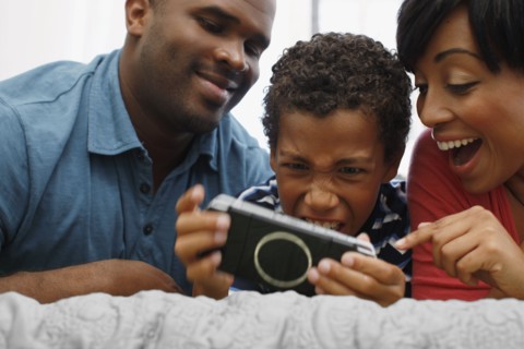 Parents watching son play video game