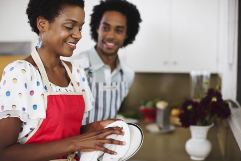 African American woman washing dishes