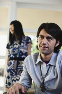 Hispanic man sitting indoors