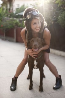 Caucasian woman in fur hat riding dog