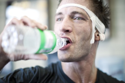 Bandaged man drinking water