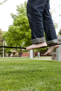 Caucasian man balancing on rope in park