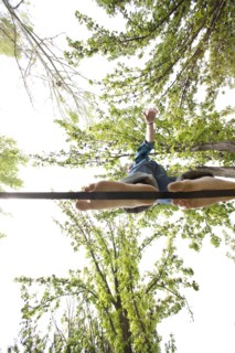 Caucasian man balancing on rope in park