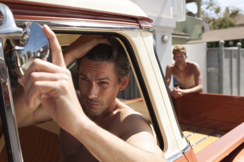 Caucasian man in truck fixing hair