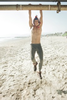 Caucasian man hanging from pipe