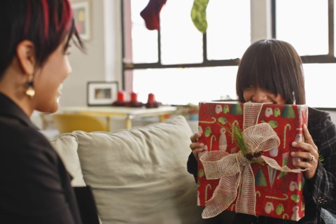 Woman holding Christmas gift for friend