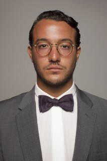 Serious Caucasian man in suit and bow tie