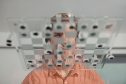 Caucasian man playing chess