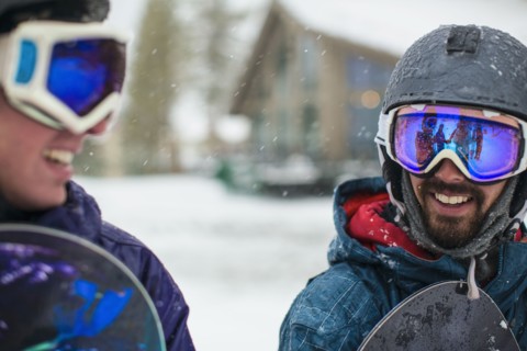 Snowboarders talking in snow