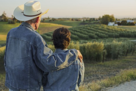 Hispanic farmers standing in vineyard