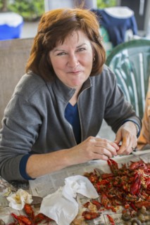 Caucasian woman eating crawfish at boil