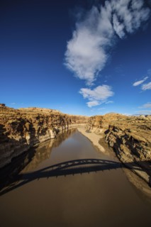Shadow of bridge over lake in dry landscape