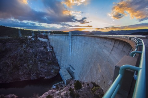 Sun rising over dam