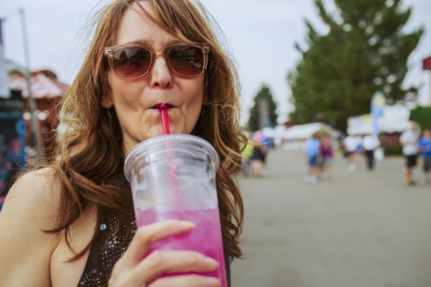 Caucasian woman drinking juice outdoors