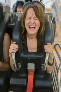 Caucasian woman shouting on roller coaster