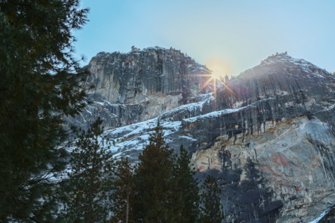 Sun rising over rocky landscape