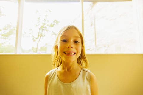 Caucasian girl showing gaps in teeth