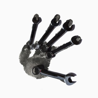 Wrenches over black handprint