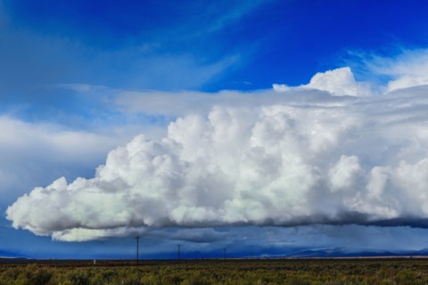 Storm clouds moving across rural prairie
