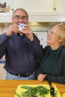 Caucasian couple cooking together in kitchen