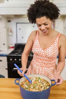 African American woman cooking in kitchen