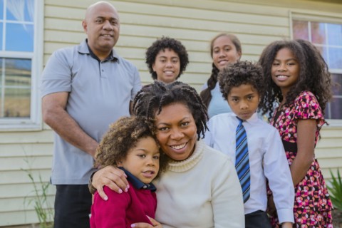 Pacific Islander family smiling outdoors