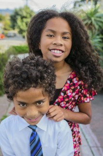 Pacific Islander brother and sister smiling outdoors