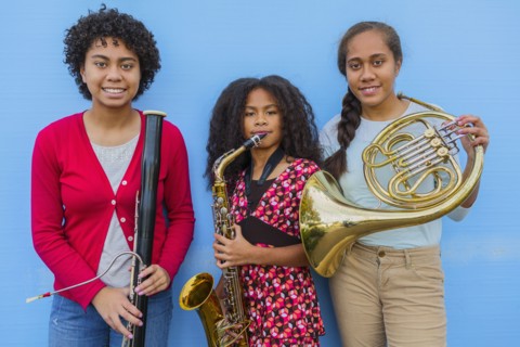 Pacific Islander girls holding musical instruments