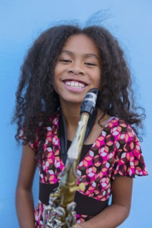 Pacific Islander girl holding saxophone