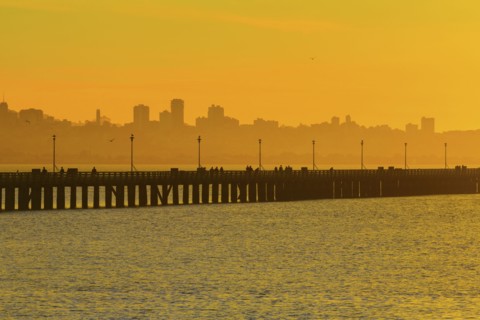 Silhouette of San Francisco city skyline over highway on bay
