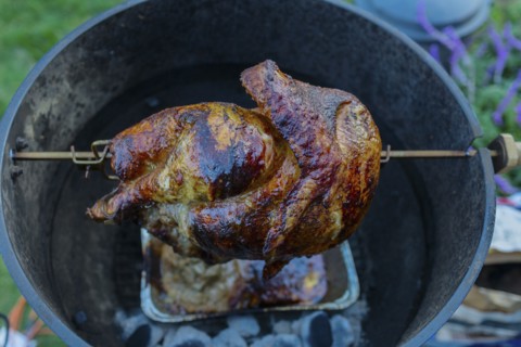 Close up of chicken cooking on rotisserie barbecue