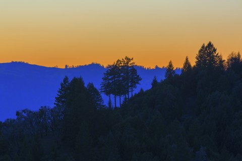 Silhouette of remote hills under sunset sky