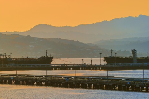 Silhouette of hills over industrial port harbor