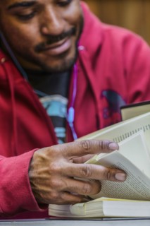 Close up of mixed race man reading book