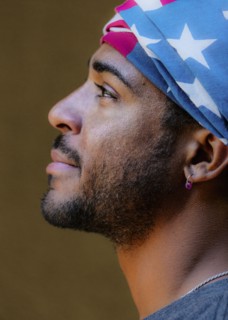 Profile of mixed race man wearing American flag turban