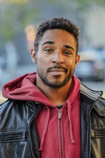 Mixed race man with raised eyebrow standing outdoors
