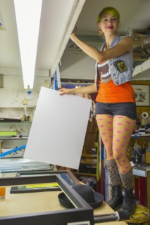 Caucasian artist working in screen print workshop