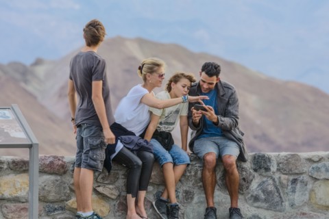 Family using cell phone at national park