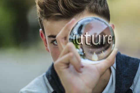 Caucasian teenage boy holding crystal ball