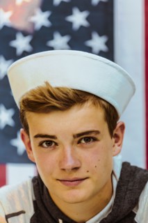Caucasian teenage boy wearing sailor hat