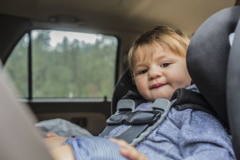 Mixed race girl sitting in car seat