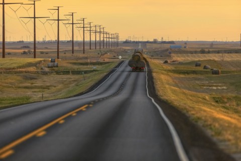 Truck carrying hay bales on rural highway