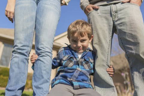 Caucasian parents and son smiling outdoors