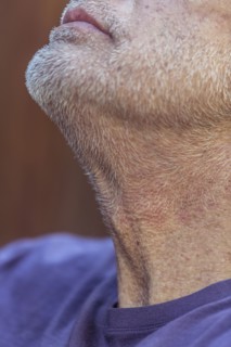 Close up of chin and beard of Caucasian man looking up