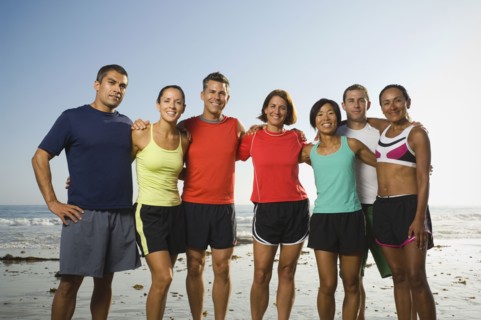 Multi-ethnic runners at beach