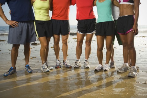 Multi-ethnic runners at beach