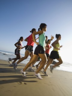 Multi-ethnic runners racing at beach