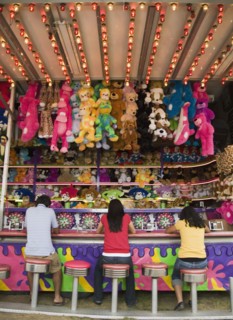 Multi-ethnic teenaged friends playing carnival game