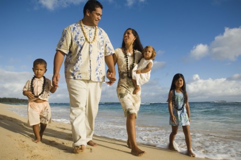 Pacific Islander family walking on beach