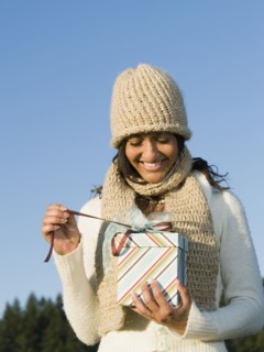 Mixed race woman opening gift